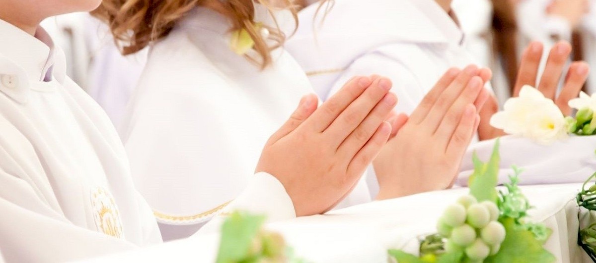 Children accepting the first Holy Communion